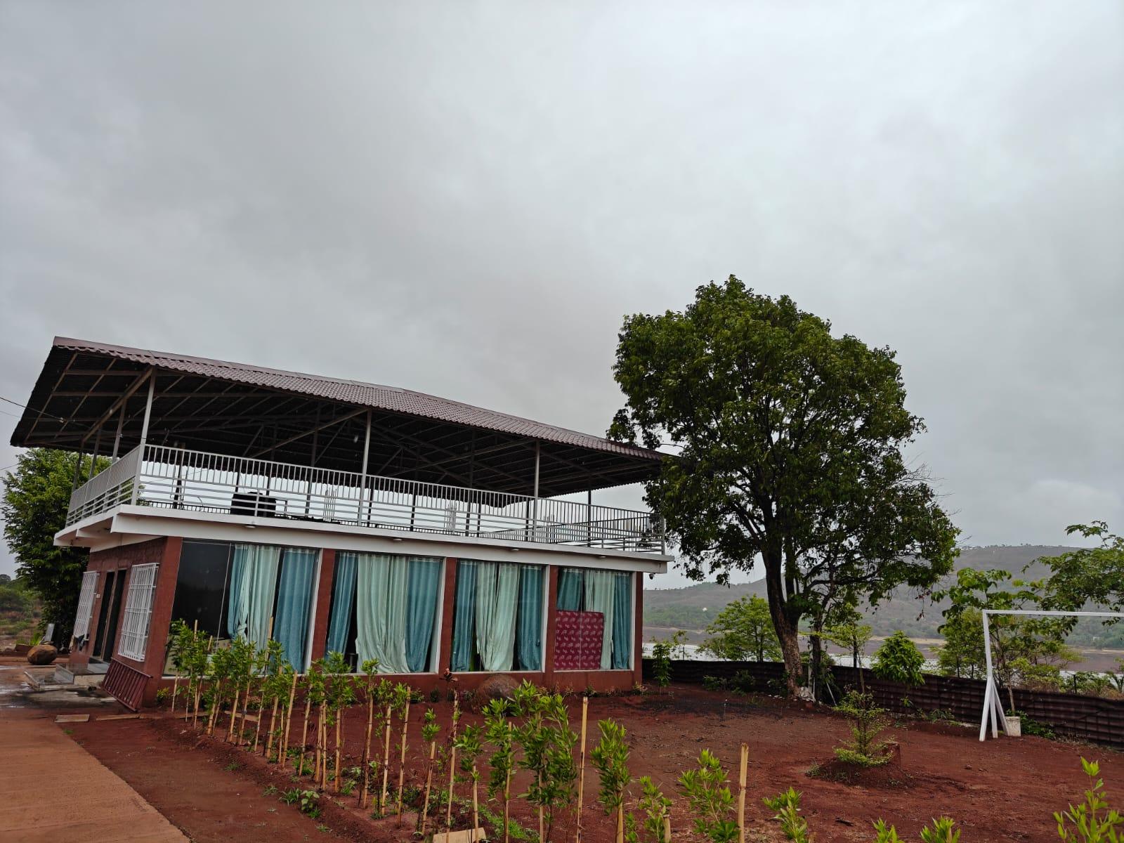 Main Aura Resort building with planted garden