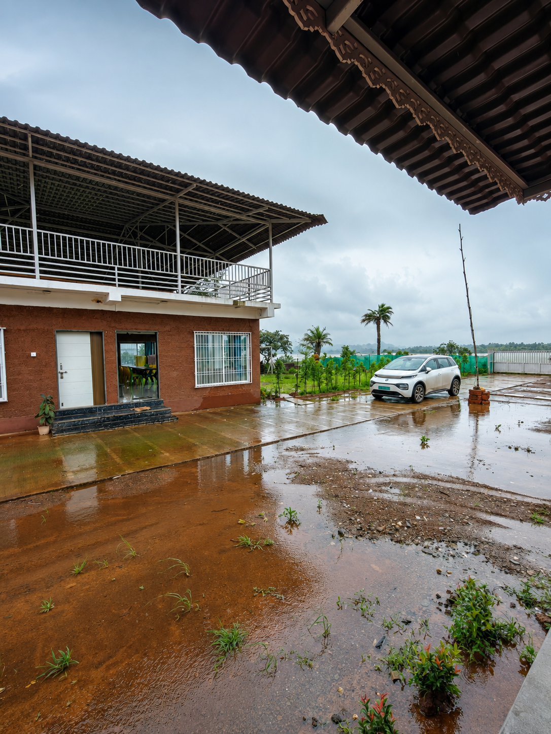 Rainy driveway and resort frontage with the lakeside landscape beyond