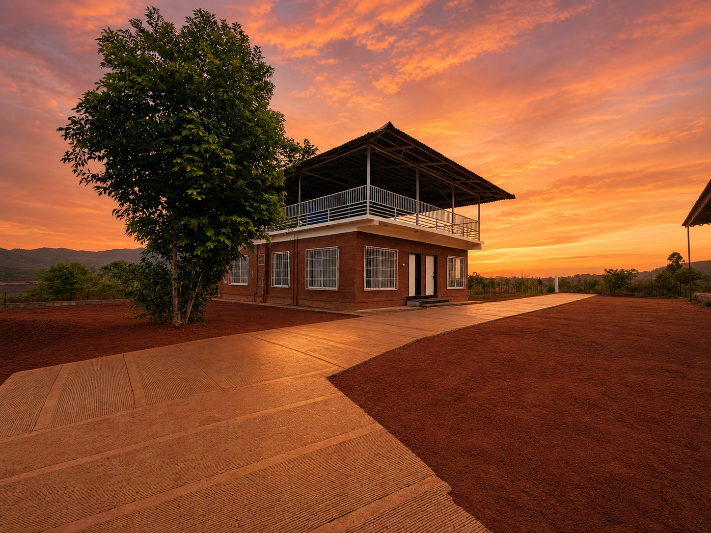 Single cottage at sunset with warm sky and open resort grounds
