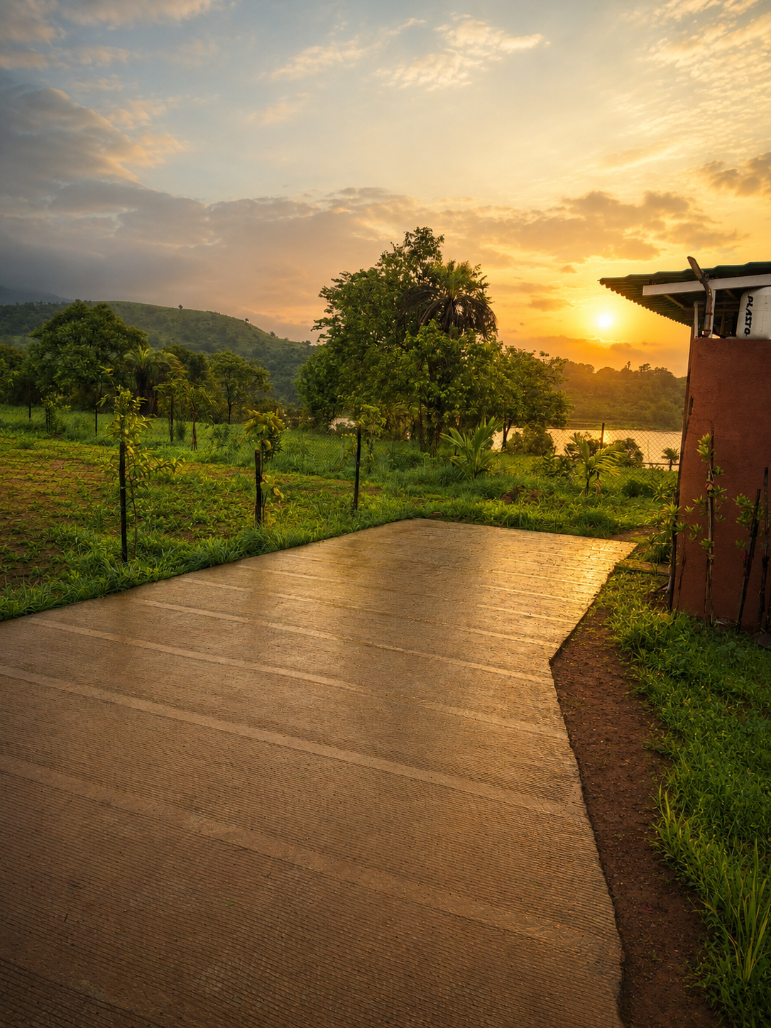 Sunset-lit driveway leading to a cottage with resort landscaping